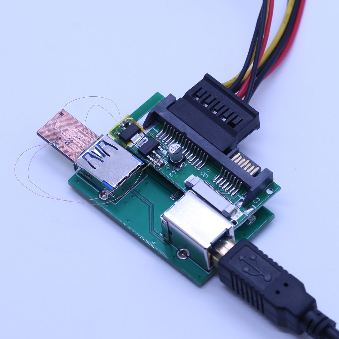 Kingston DTSE39H after data extraction — monolithic chip with the extraction wires attached
