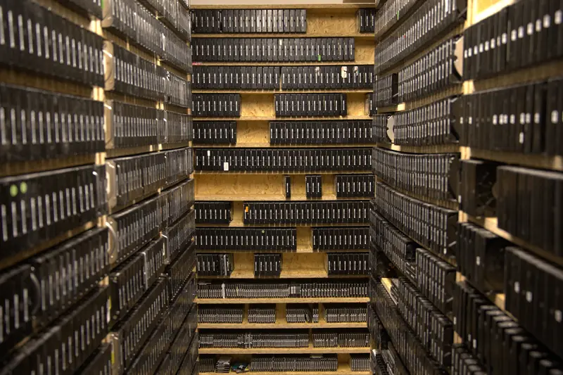 Vertical aisle of the HDD archive — dramatic low lighting of the shelves